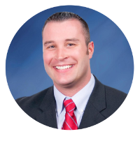 Headshot of the Banccard Representive at Kentucky Farmers Bank. He is smiling and wearing a black suit with a blue solid background.